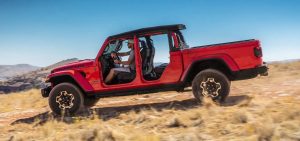 Red 2021 Jeep Gladiator Driving Down a Hill