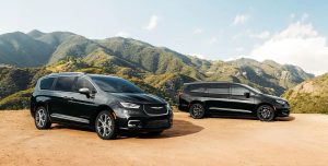 Two Black 2021 Chrysler Pacificas in Front of Hills